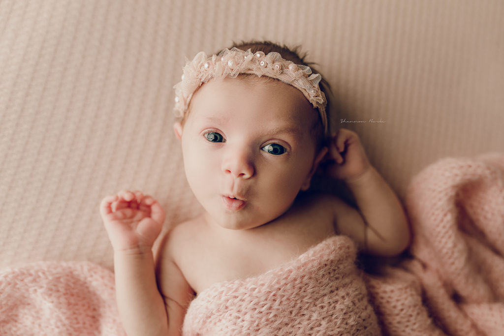 newborn baby girl pink eyes open